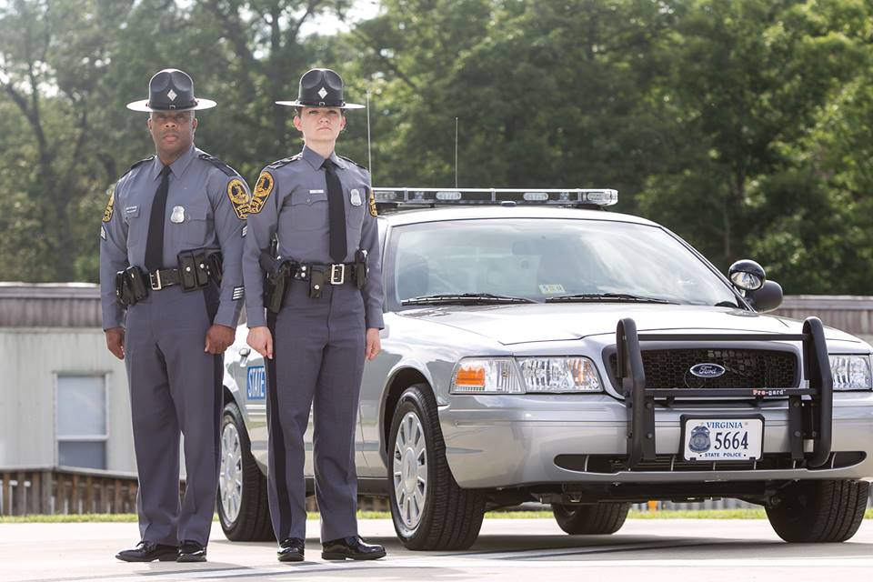 Police officers standing in front of car